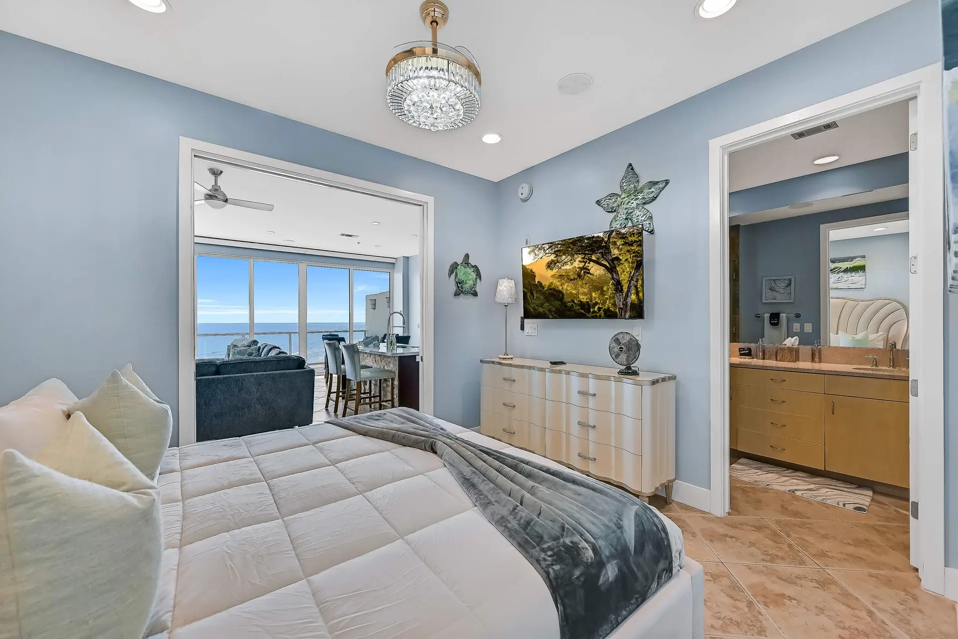 image of a luxurious bed queen size bed with the beach view out the window